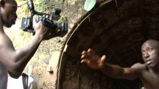 Director Arthur Pratt ant the team from WeOwnTV shooting at King Jimmy Market, Freetown. Video Still from the film "Shooting Freetown" (2011) by Kieran Hanson.